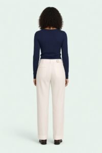 ASSANE, genderless straight-leg trousers worn, back view on a green background