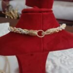 Collier torsadé doré et argenté avec fermoir à anneau, sur buste rouge, Idrissi's brand