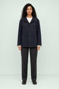 RARI, genderless chore jacket worn, front view on a green background