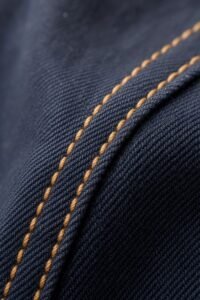 RARI, close-up of the navy cotton canvas and ochre topstitching